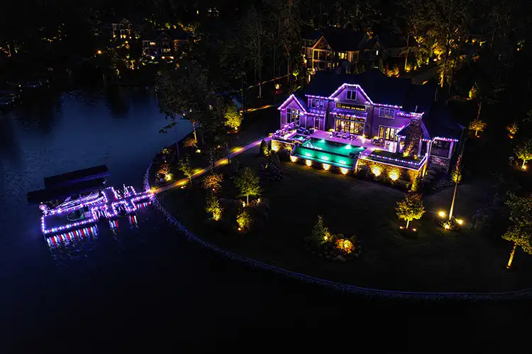 aerial photo of luxury home lit up at night